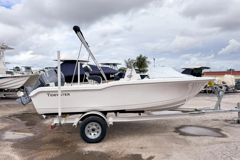 Slide: The Image of 2026 Tidewater 180 CC Adventure boat on trailer, parked outdoors under cloudy sky. - 4