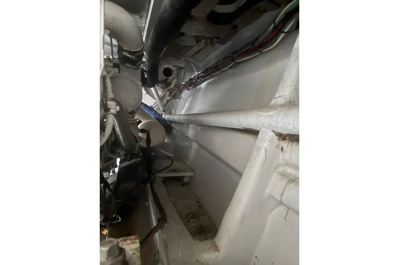 Slide: The Image of Engine room of 1983 Hines-Farley 34 Express boat, showing pipes and wiring. - 12