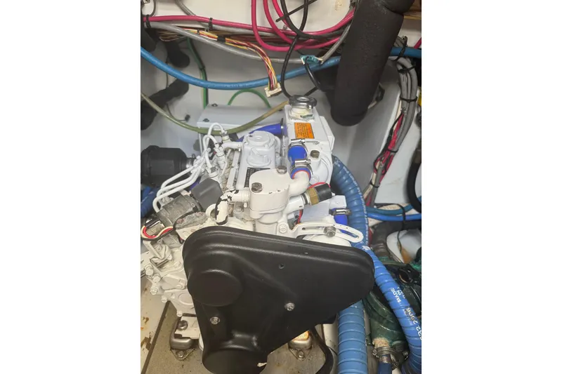 Slide: The Image of Engine compartment of a 1983 Hines-Farley 34 Express boat with visible wiring and components. - 13