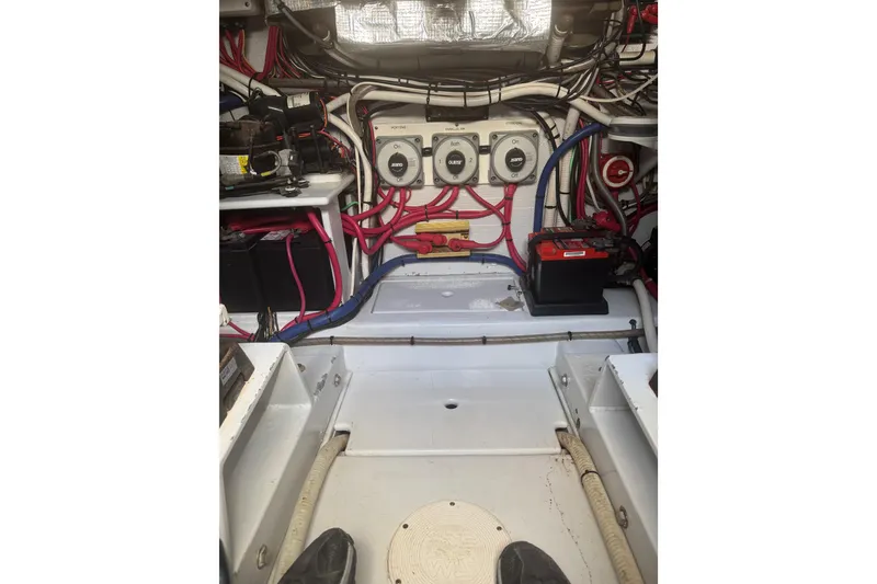 Slide: The Image of Engine room of 1983 Hines-Farley 34 Express with wiring and battery setup. - 15