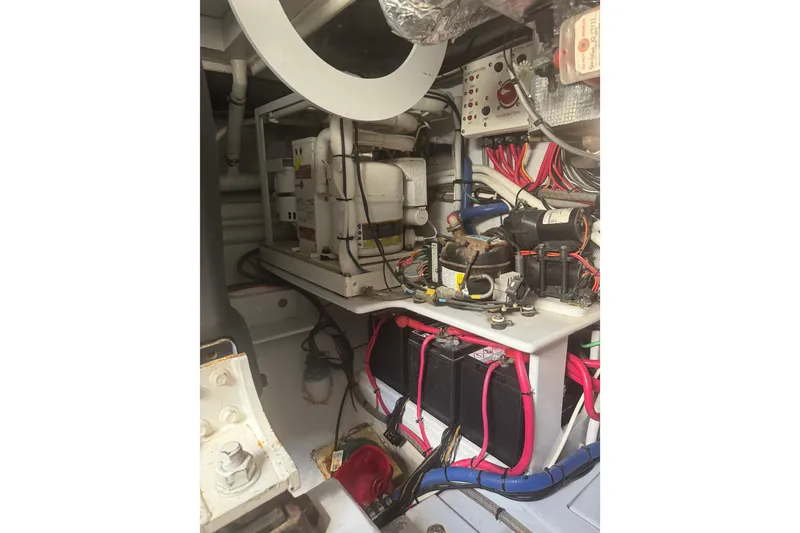 Slide: The Image of Engine room of 1983 Hines-Farley 34 Express, showcasing electrical components and wiring. - 16