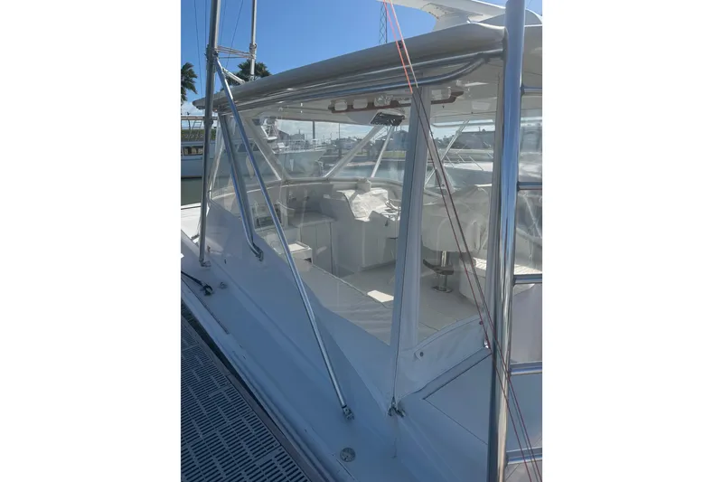 Slide: The Image of 1983 Hines-Farley 34 Express boat with clear enclosure and visible seating area. - 17