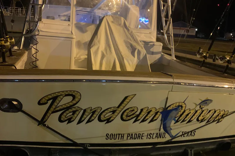 Slide: The Image of 1983 Hines-Farley 34 Express boat named "Pandemonium" docked at night, South Padre Island. - 5