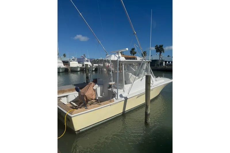 Slide: The Image of 1983 Hines-Farley 34 Express boat docked in sunny marina setting. - 8