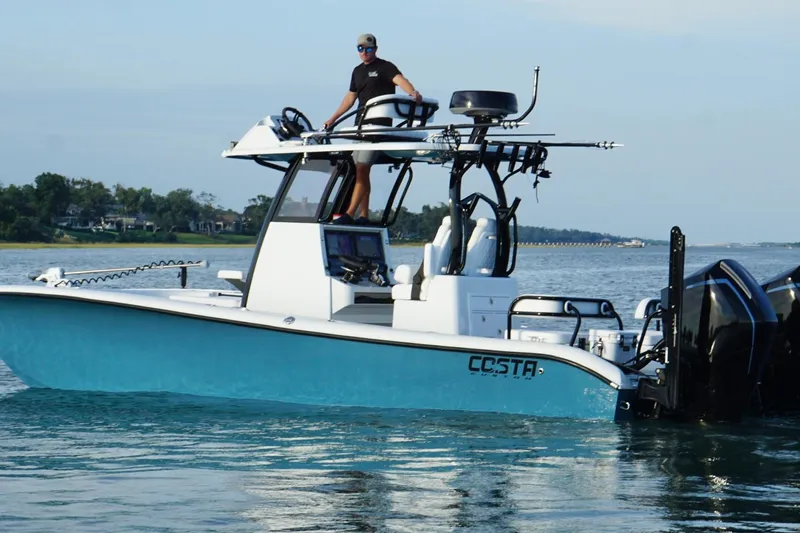 Slide: The Image of Helm of 2025 Costa Custom Boats 264 HC with advanced navigation displays and controls. - 13