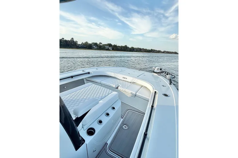 Slide: The Image of 2025 Costa Custom Boats 264 HC on calm water, showcasing sleek design and spacious seating. - 16