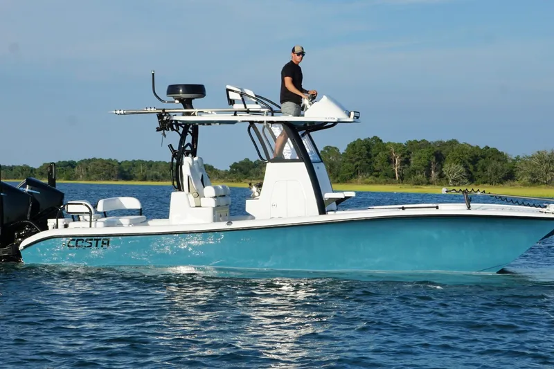 Slide: The Image of 2025 Costa Custom Boats 264 HC cruising on a scenic waterway. - 3