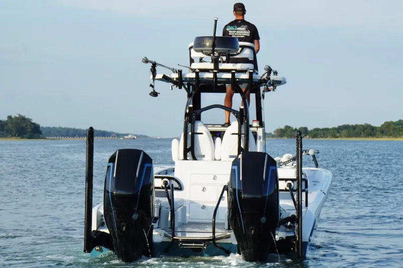 Slide: The Image of 2025 Costa Custom Boats 264 HC on water, rear view with dual engines. - 5