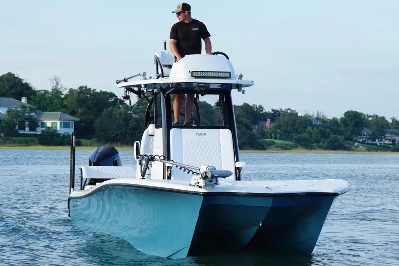 Slide: The Image of 2025 Costa Custom Boats 264 HC on water, sleek design, blue hull, modern features. - 6