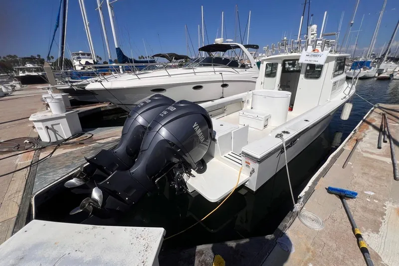 Slide: The Image of 2023 Parker 2820 XLD Sport Cabin boat docked with twin Yamaha outboard engines. - 14