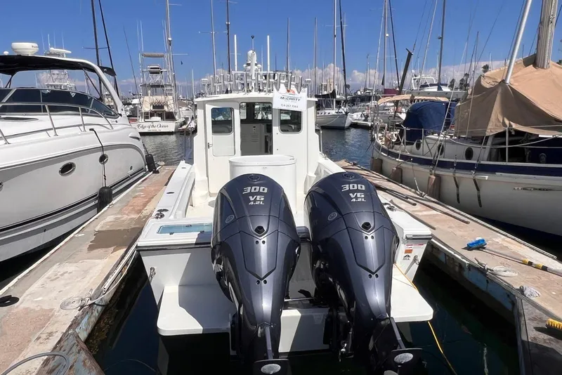 Slide: The Image of 2023 Parker 2820 XLD Sport Cabin boat docked with twin 300 V6 engines. - 15