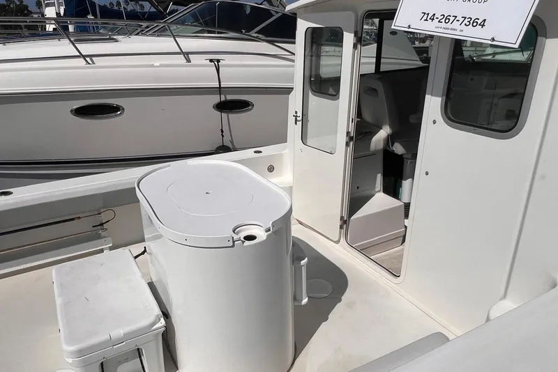 Slide: The Image of 2023 Parker 2820 XLD Sport Cabin boat interior with open cabin door. - 18