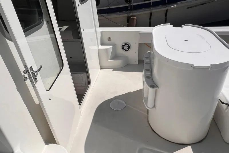 Slide: The Image of 2023 Parker 2820 XLD Sport Cabin boat interior with door and storage area. - 5