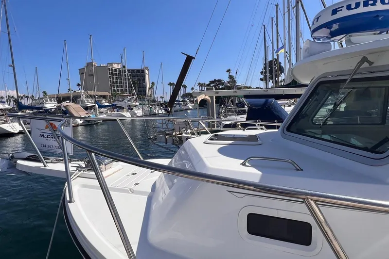 Slide: The Image of 2023 Parker 2820 XLD Sport Cabin boat docked in marina, surrounded by sailboats. - 7