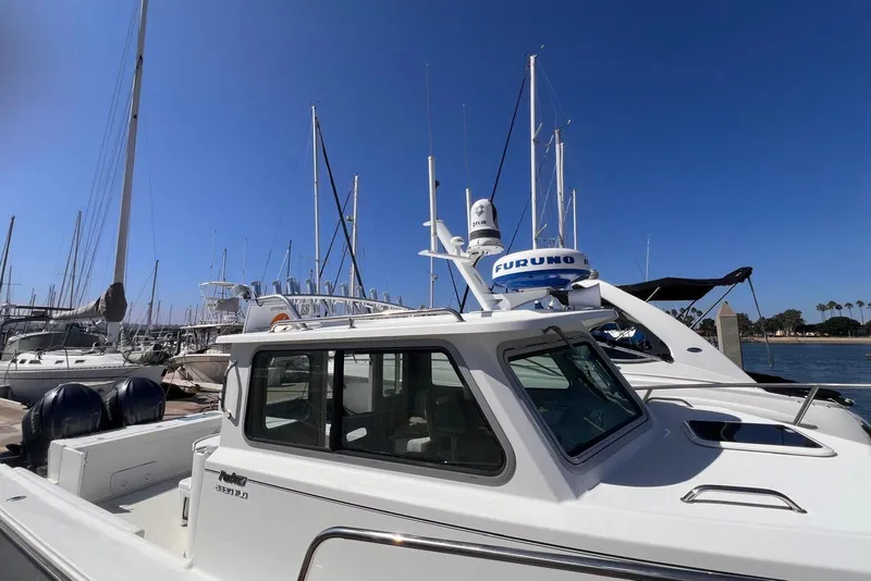 Slide: The Image of 2023 Parker 2820 XLD Sport Cabin boat docked at marina under clear blue sky. - 9
