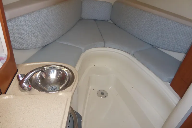Slide: The Image of 2006 Hydra-Sports Vector 2900 VX cabin interior with sink and cushioned seating. - 10