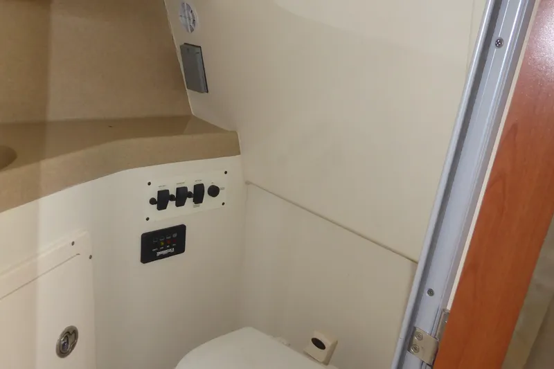 Slide: The Image of 2006 Hydra-Sports Vector 2900 VX boat interior with control panel and storage. - 11