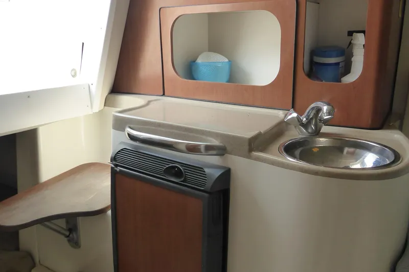 Slide: The Image of 2006 Hydra-Sports Vector 2900 VX boat interior with sink, countertop, and storage. - 14