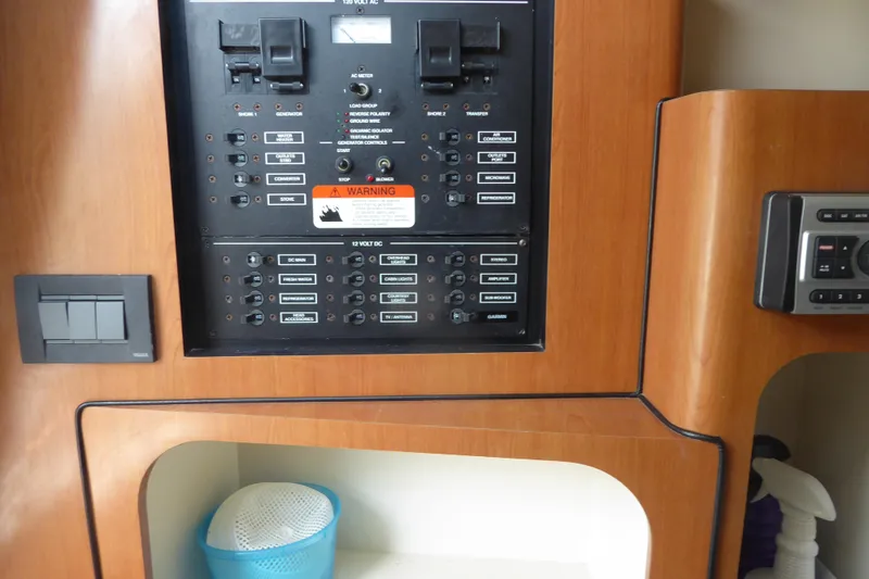 Slide: The Image of Control panel of a 2006 Hydra-Sports Vector 2900 VX boat, featuring switches and warning labels. - 18