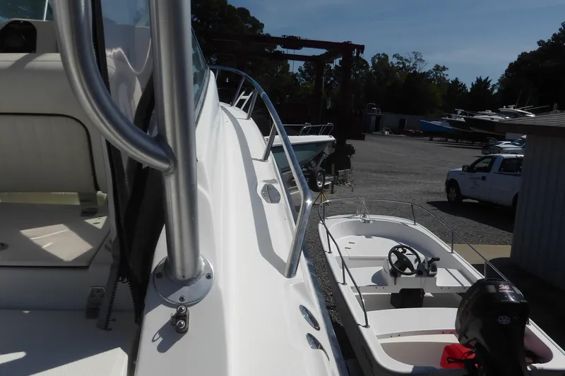 Slide: The Image of 2006 Hydra-Sports Vector 2900 VX boat docked, with smaller boat and vehicles nearby. - 45