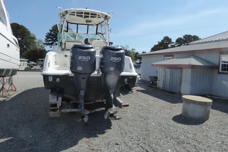 Slide: The Image of 2006 Hydra-Sports Vector 2900 VX boat with dual Yamaha 250 engines, parked outdoors. - 6