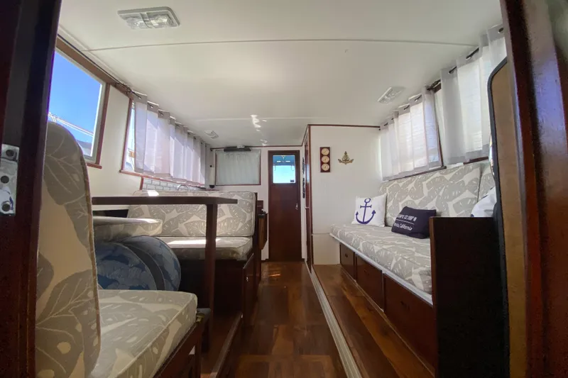 Slide: The Image of 1976 Uniflite Sport Flybridge interior with nautical decor and wood flooring. - 14