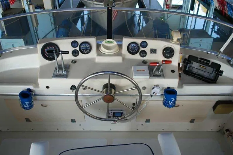 Slide: The Image of 1976 Uniflite Sport Flybridge helm with steering wheel, gauges, and controls. - 17