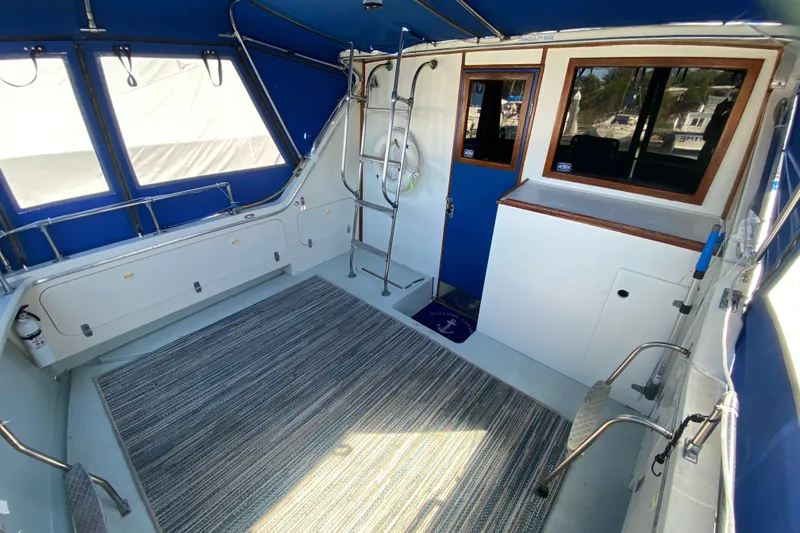 Slide: The Image of 1976 Uniflite Sport Flybridge interior with blue accents and striped carpet. - 5