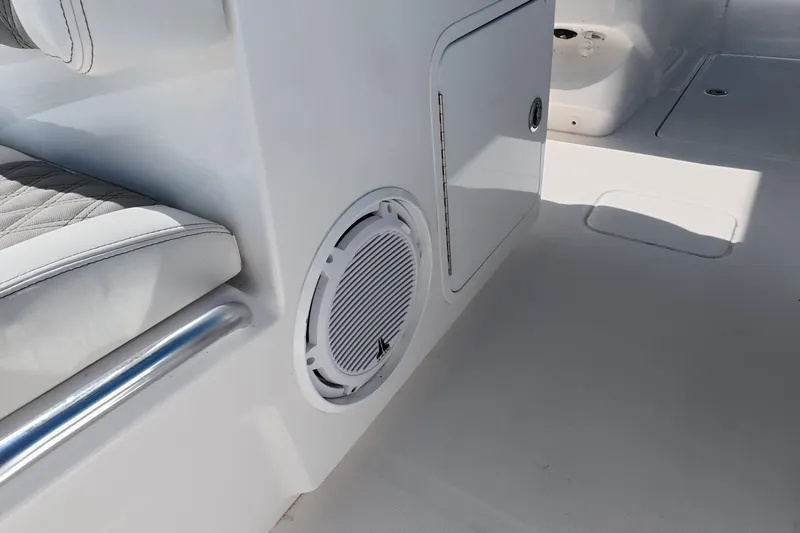 Slide: The Image of 2023 Invincible 33 Catamaran interior with speaker and cushioned seating detail. - 14