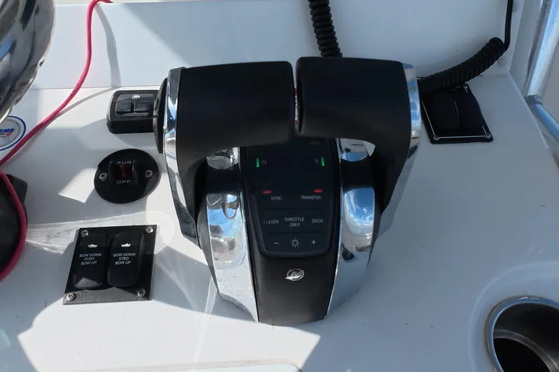Slide: The Image of Throttle controls on 2023 Invincible 33 Catamaran dashboard, featuring modern navigation equipment. - 16