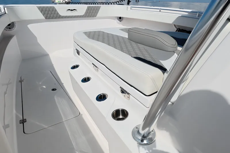 Slide: The Image of 2023 Invincible 33 Catamaran interior with cushioned seating and stainless steel cup holders. - 18