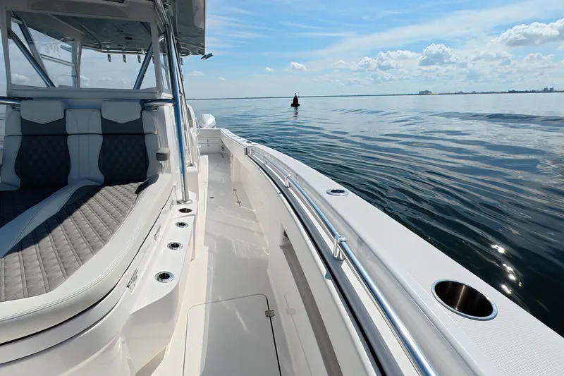 Slide: The Image of 2023 Invincible 33 Catamaran on calm waters, showcasing sleek design and luxurious seating. - 19