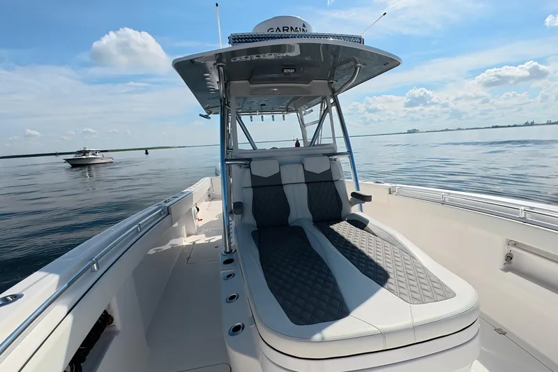 Slide: The Image of 2023 Invincible 33 Catamaran on calm waters, featuring sleek seating and modern design. - 20