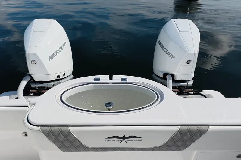 Slide: The Image of 2023 Invincible 33 Catamaran with dual Mercury engines on calm water. - 25