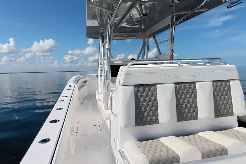 Slide: The Image of 2023 Invincible 33 Catamaran on calm water, featuring sleek design and luxurious seating. - 26