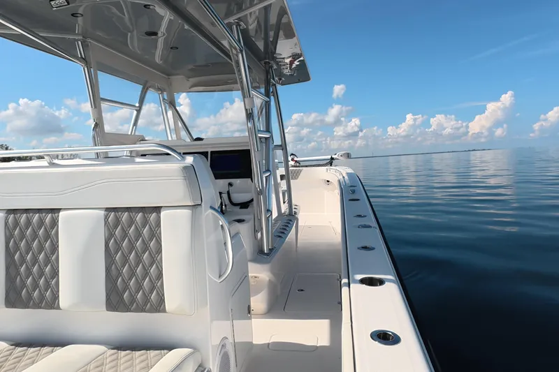 Slide: The Image of 2023 Invincible 33 Catamaran on calm water, featuring sleek design and luxurious seating. - 30