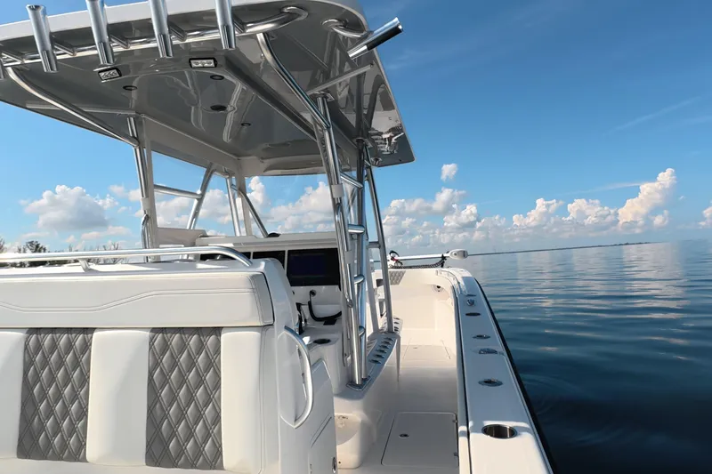 Slide: The Image of 2023 Invincible 33 Catamaran on calm water, showcasing sleek design and luxury seating. - 31