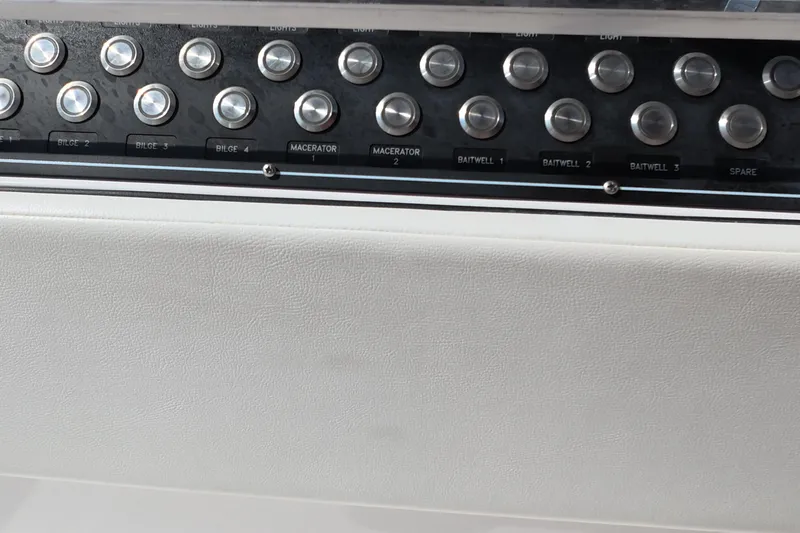 Slide: The Image of Control panel of 2023 Invincible 33 Catamaran with labeled buttons for bilge and baitwell. - 34