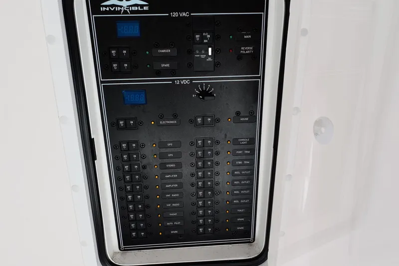 Slide: The Image of Electrical control panel of 2023 Invincible 33 Catamaran, featuring 120 VAC and 12 VDC systems. - 39