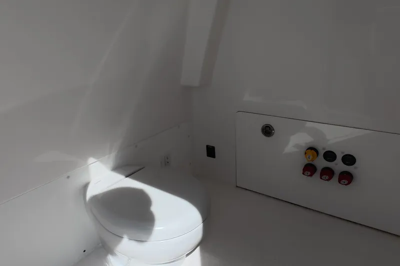 Slide: The Image of Interior of 2023 Invincible 33 Catamaran featuring a compact marine toilet. - 41
