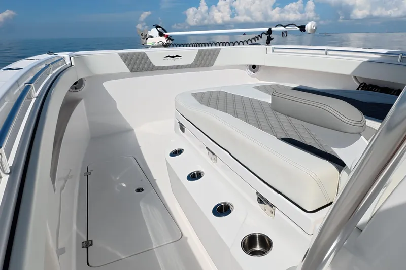 Slide: The Image of 2023 Invincible 33 Catamaran interior with cushioned seating and stainless steel cup holders. - 42