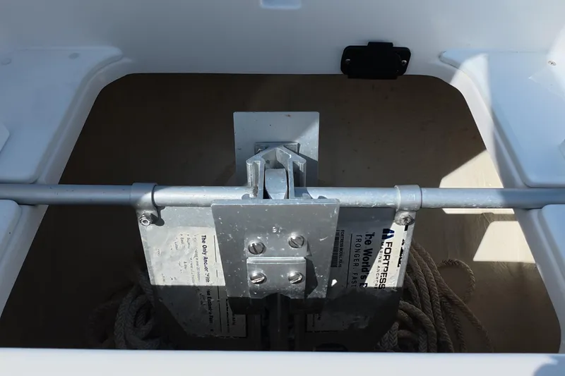 Slide: The Image of Anchor storage compartment on 2023 Invincible 33 Catamaran, featuring a Fortress anchor and rope. - 44
