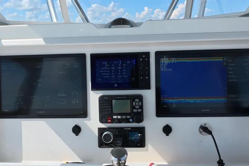 Slide: The Image of Dashboard of 2023 Invincible 33 Catamaran with Garmin navigation displays and controls. - 5