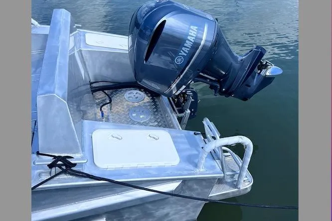 Slide: The Image of 2025 Gospel Boat Landing Craft with Yamaha outboard motor on calm water. - 6