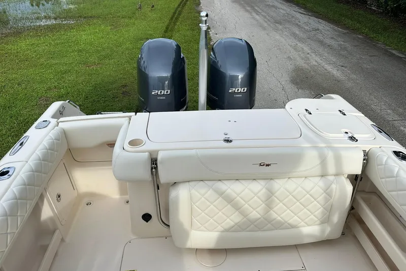 Slide: The Image of 2011 Grady-White Freedom 275 boat with twin Yamaha 200 engines, docked on grass. - 12
