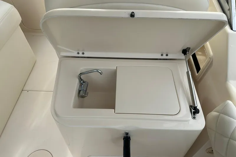 Slide: The Image of 2011 Grady-White Freedom 275 boat sink with closed lid and faucet. - 17