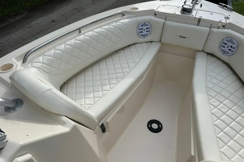 Slide: The Image of 2011 Grady-White Freedom 275 boat interior with white quilted seating and speakers. - 22