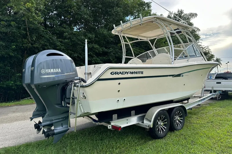 Slide: The Image of 2011 Grady-White Freedom 275 boat on trailer with Yamaha engine, parked outdoors. - 3