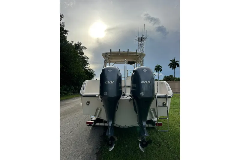 Slide: The Image of 2011 Grady-White Freedom 275 boat with dual Yamaha 200 engines, parked on grass. - 4