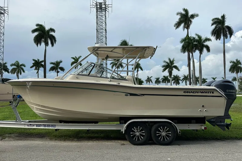 Slide: The Image of 2011 Grady-White Freedom 275 boat on trailer, palm trees in background. - 6